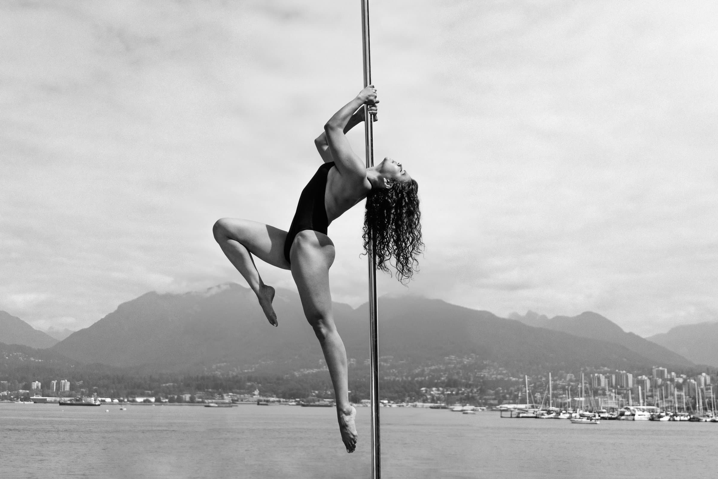 Karen on a pole against the Vancouver skyline