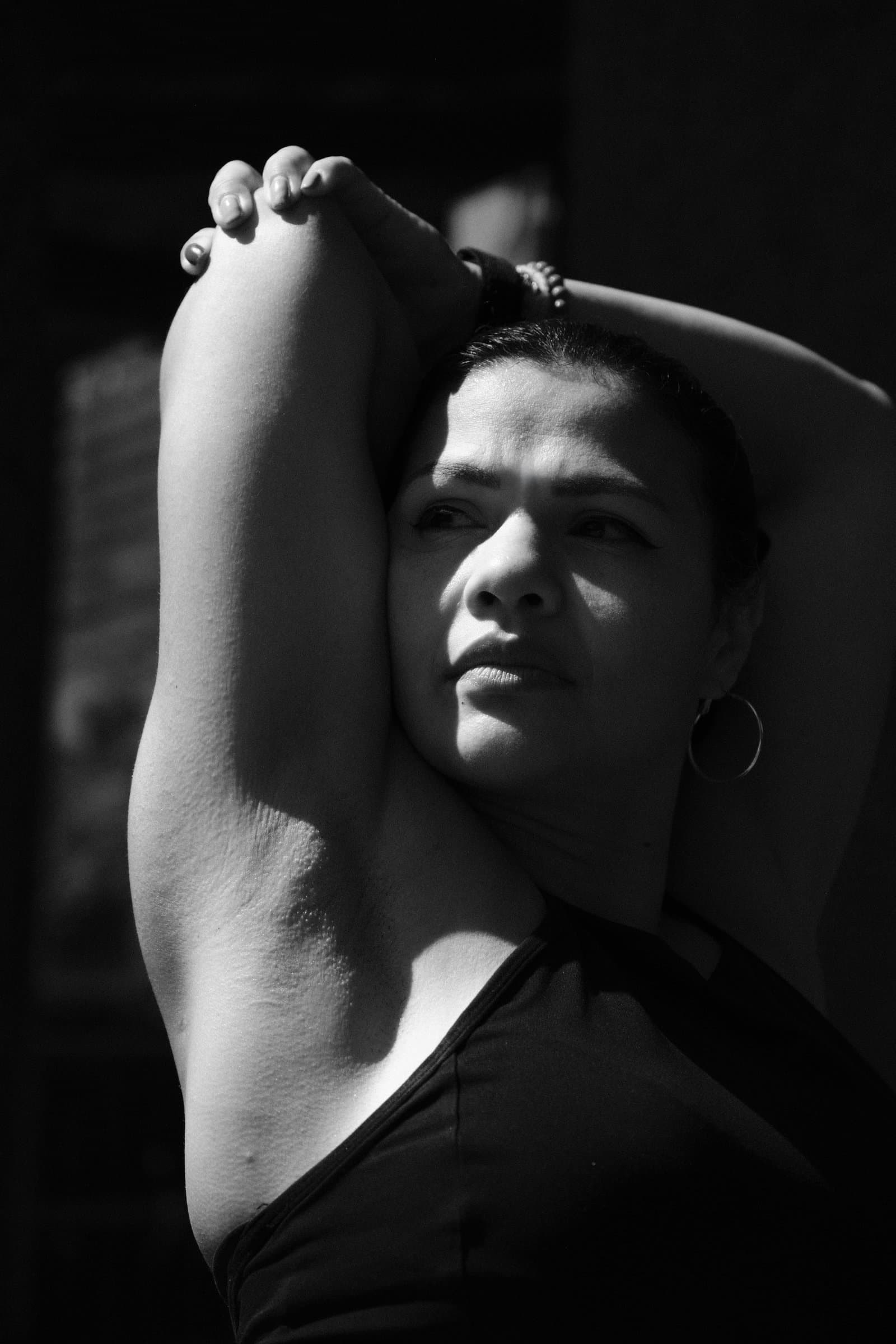 Karen, arms raised, in black and white